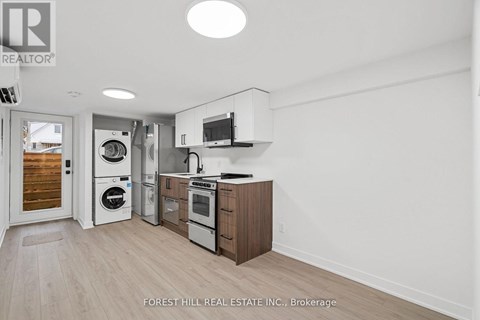 A kitchen with a washer and dryer built in.