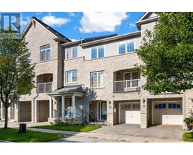 A large, multi-story residential building with a balcony and garage doors.