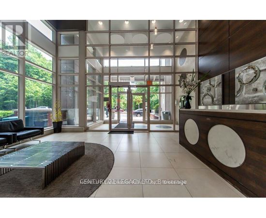 A reception area with a wooden counter and a glass wall.