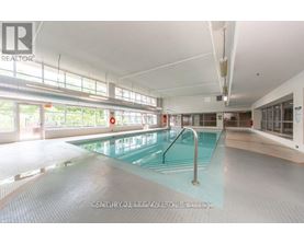 A large indoor swimming pool with a glass bottom.