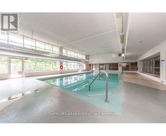 A large indoor swimming pool with a glass bottom.