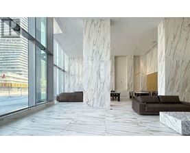 A spacious lobby with marble floors and columns.