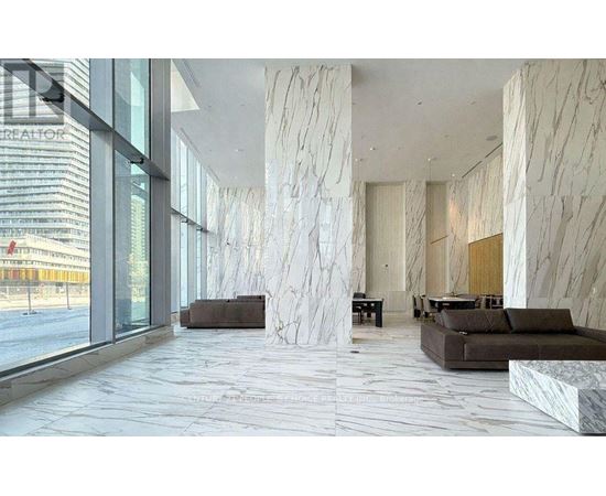 A spacious lobby with marble floors and columns.
