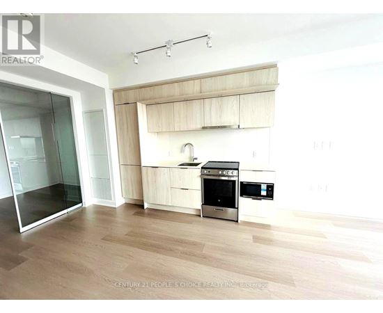A modern kitchen with wooden cabinets and stainless steel appliances.