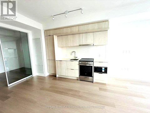 A modern kitchen with wooden cabinets and stainless steel appliances.