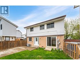 A house with a white exterior and a brown fence is for sale.