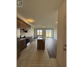 A spacious kitchen with a dining table and chairs in a house.