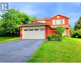 A red brick house with a white garage door is for sale.