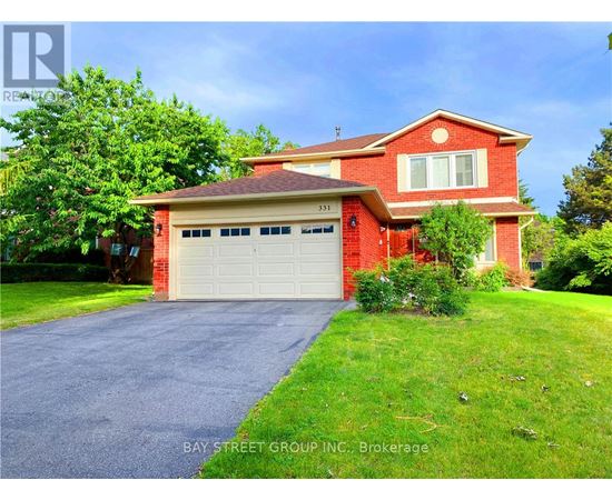 A red brick house with a white garage door is for sale.