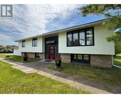 A house with a red door and a sign that says REALTOR.
