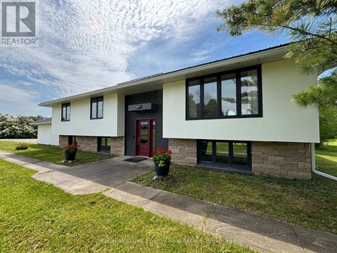 A house with a red door and a sign that says REALTOR.