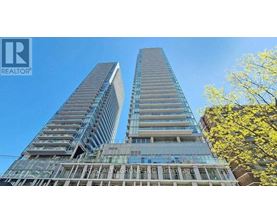 Two tall buildings with glass windows and balconies are under construction.