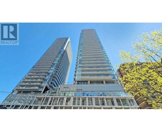 Two tall buildings with glass windows and balconies are under construction.