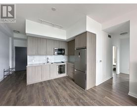A modern kitchen with wooden cabinets and stainless steel appliances.