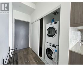 A washer and dryer are stacked on top of each other in a laundry room.