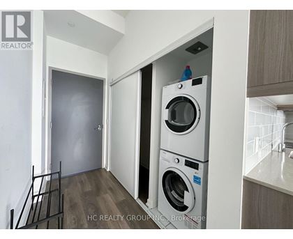 A washer and dryer are stacked on top of each other in a laundry room.