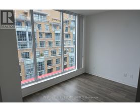 A room with a large window overlooking a building.