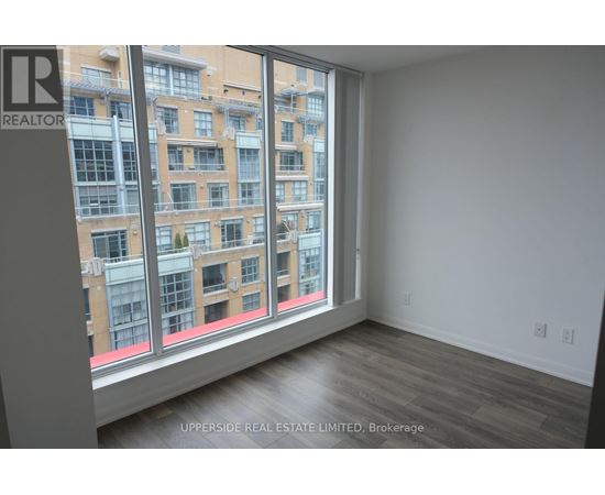 A room with a large window overlooking a building.