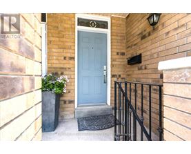 A blue door is on the right side of a brick wall.