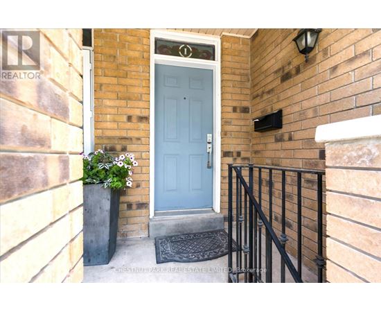 A blue door is on the right side of a brick wall.