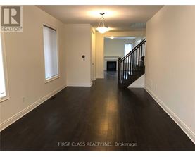 A long hallway with a staircase on the right side.