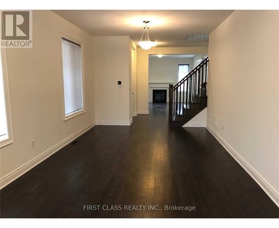 A long hallway with a staircase on the right side.