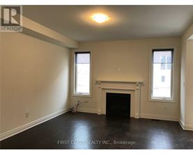 A room with a fireplace and two windows.
