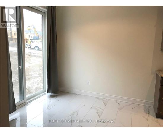 A room with a marble floor and a sliding glass door.