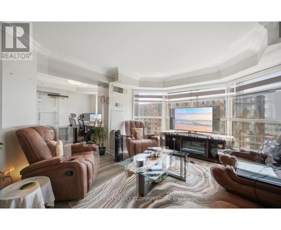 A living room with brown leather furniture and a large window overlooking a cityscape.