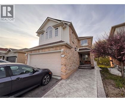 A house with a car parked in front of it.