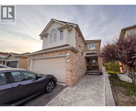 A house with a car parked in front of it.