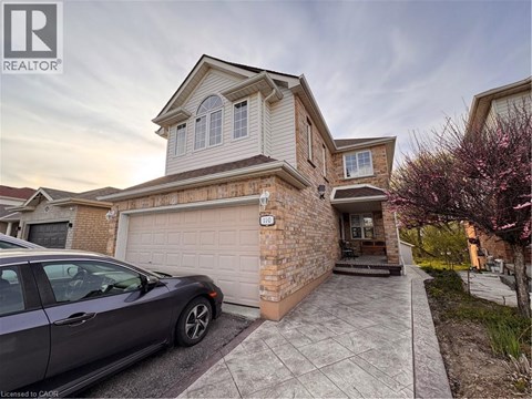 A house with a car parked in front of it.