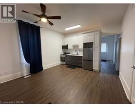 A well-lit, spacious kitchen area with wooden flooring and modern appliances.