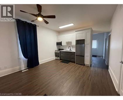 A well-lit, spacious kitchen area with wooden flooring and modern appliances.