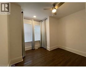 A room with a ceiling fan and sliding glass doors.