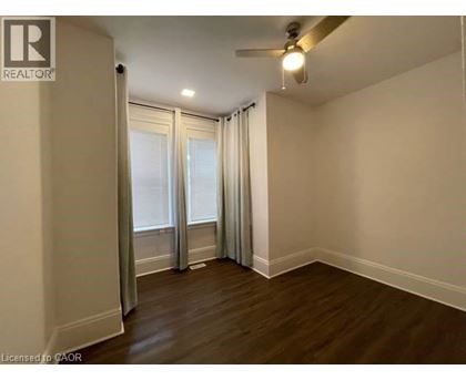 A room with a ceiling fan and sliding glass doors.