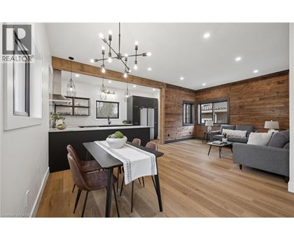 A modern dining room with a wooden table and chairs.