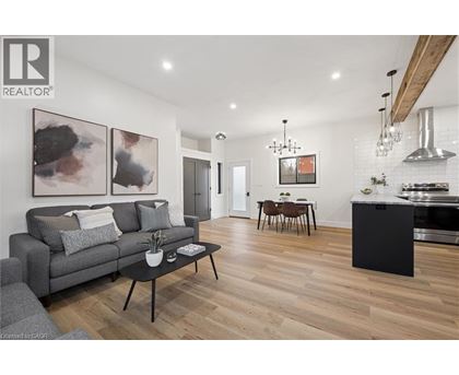 A modern living room with a grey couch and a black coffee table.