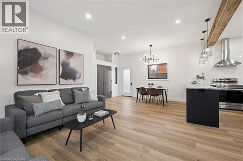 A modern living room with a grey couch and a black coffee table.