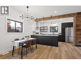 A modern kitchen with a dining table and chairs.