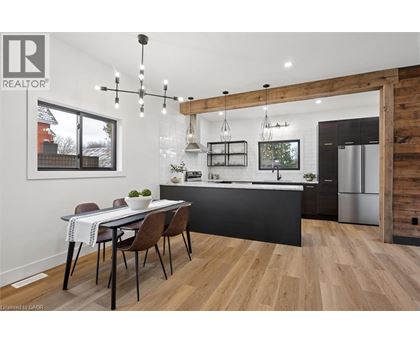 A modern kitchen with a dining table and chairs.