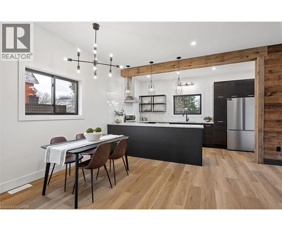 A modern kitchen with a dining table and chairs.