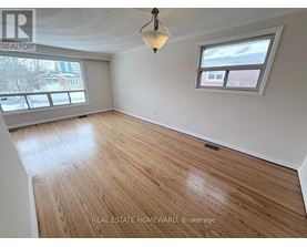 A room with wooden flooring and a window.