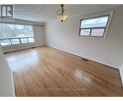 A room with wooden flooring and a window.