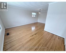 A room with wooden flooring and a window.