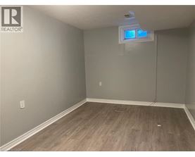 A room with a window and wooden flooring.