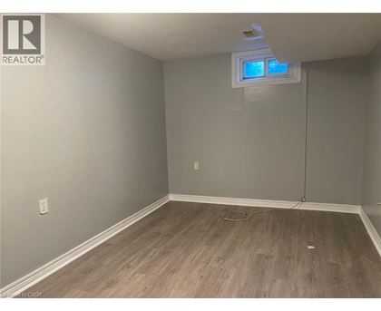 A room with a window and wooden flooring.
