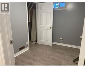 A room with a white door and a grey wall.