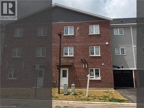 A red brick house with a white door and a sign that says REALTOR.