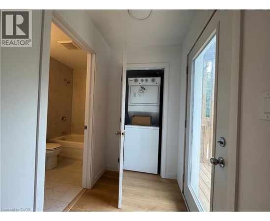 A white refrigerator is in a kitchen with a door open.